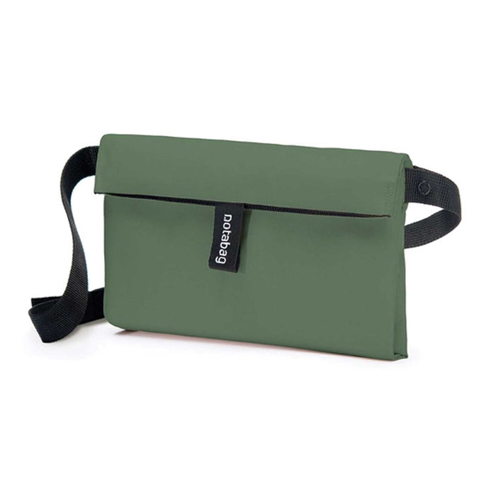 green body small bag with black tab with Notabag written in white lettering and black strap on bag
