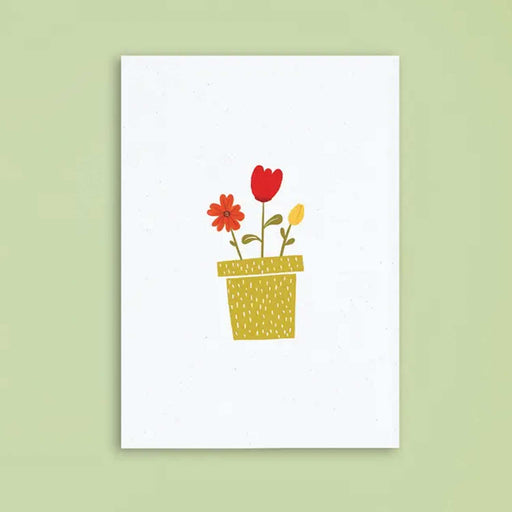 white greeting card with no text and drawing of plant pot with 2 red flowers and 1 yellow flower in it card is against a green background