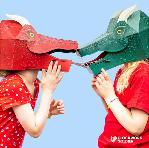 two children wearing a green and a red dragon mask