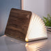 fanned book light open on a desk with a notebook  in the background