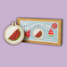 Cross stitch mini kit with watermelon design and 'You're one in a melon' text on a purple background