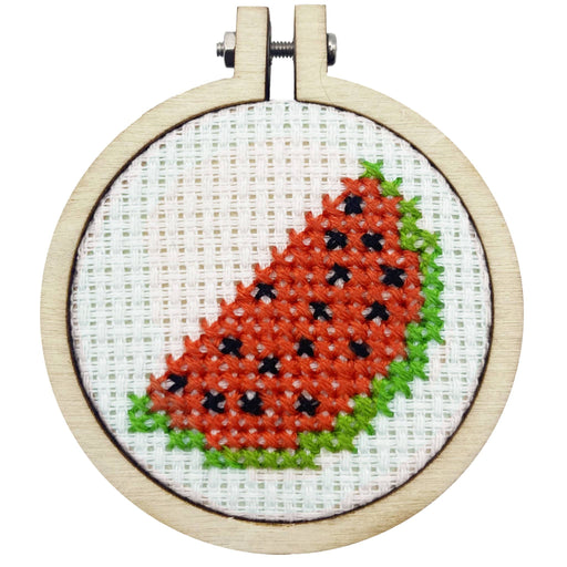 Cross-stitched watermelon design in a wooden hoop on a white background
