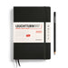 2025 daily diary, black with white paper title banner, black elastic and two black ribbons