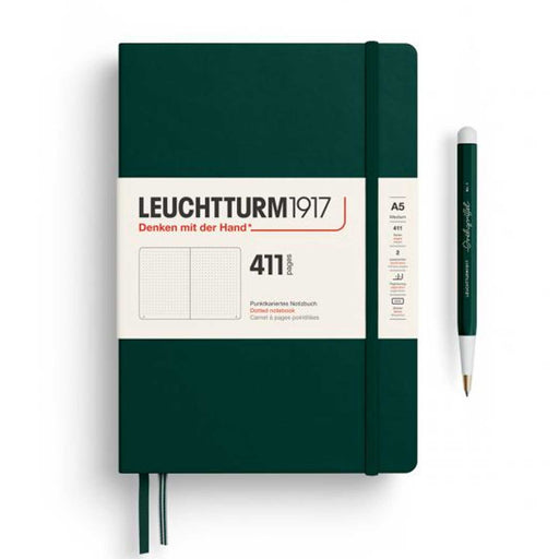 A5 411 GREEN LEUCHTTURM NOTEBOOK WITH WHITE BANNER WRAP, GREEN ELASTIC, TWO RIBBON PAGE MARKERS AND GREEN PEN TO RIGHT OF NOTEBOOK