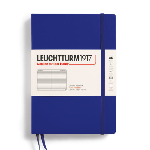 blue a5 ruled leuctturm notebook with blue elastic band and two blue ribbon page markers. white paper band around cover