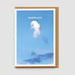 Framed artwork with a cloud-like character and 'SENDING LOVE' text against a blue sky.