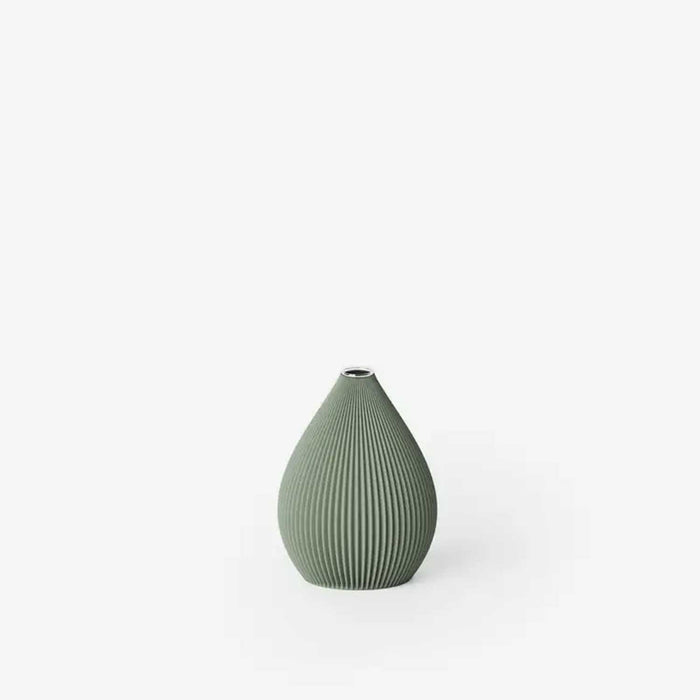 Green ribbed vase on a white background