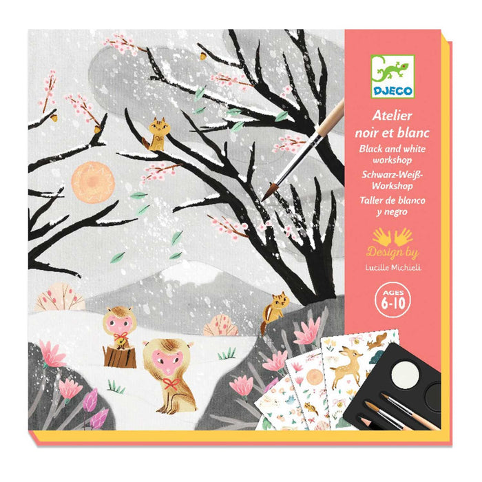 Black & White Workshop product box with pink strip on the right of the box and image of black trees with no leave and two brown monkeys on a snowy ground underneath