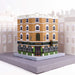 cardboard model of a redbrick and green tiled three story building with a pub on ground floor and double doors on the corner
