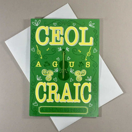 green greeting card with green violin in the centre and yellow text, musical notes and white hearts