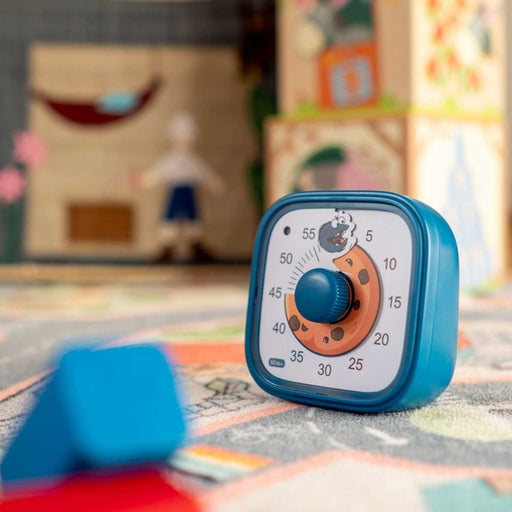 Blue timer on a colorful rug with a blurred background