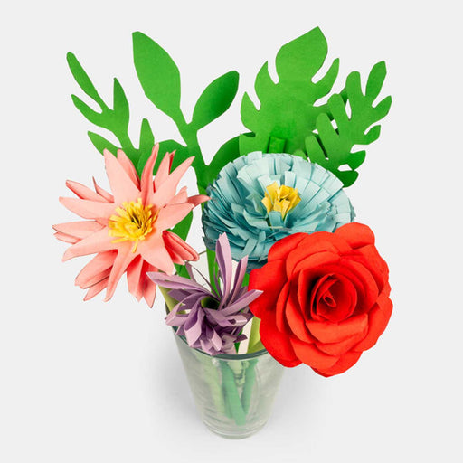 a bunch of 4 paper flowers, red, pink, blue and purple in a glass vase with green paper leaves