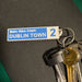 Keychain with 'Dublin Town' tag on a dark surface