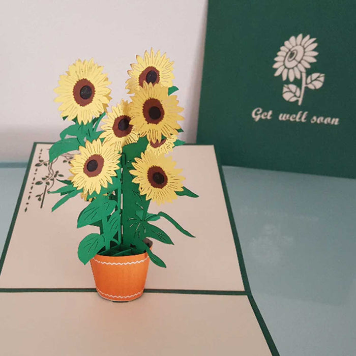 green get well soon pop up greeting card with pop out pot plant of five yellow sunflowers with green leaves and stems