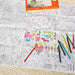 Coloring poster with farm animals and coloring pencils on a textured surface