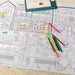 Coloring poster with a street scene and colored pencils on a textured surface