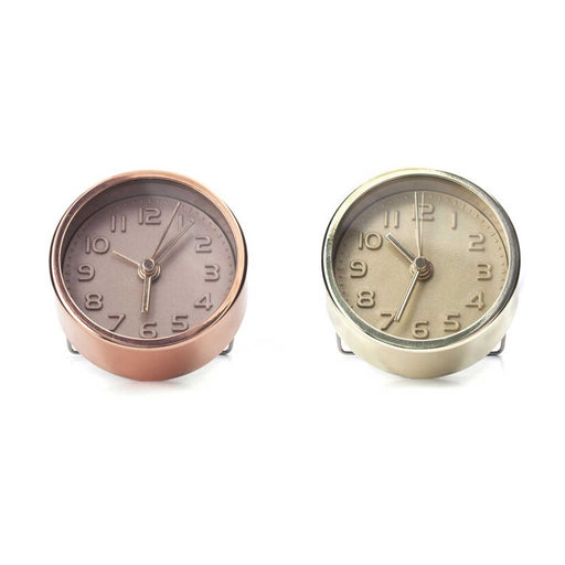 two small round alarm clocks with numbers and 3 hands on clockface one clock is gold and one is copper
