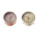 two small round alarm clocks with numbers and 3 hands on clockface one clock is gold and one is copper
