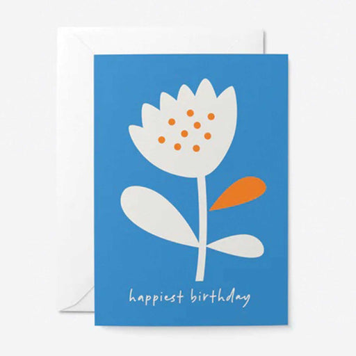 blue greeting card with white graphic flower with 9 orange spots two white leaves and 1 orange leaf. Happiest Birthing in white text below