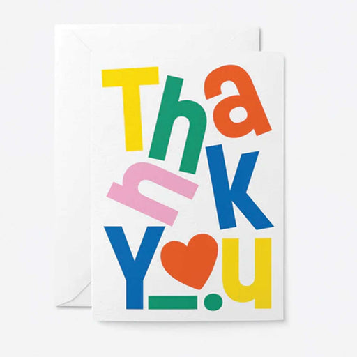 white greeting card with thank you in jumbled colourful letters  and red love heart