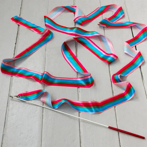 Colorful ribbon with a stick on a light wooden surface