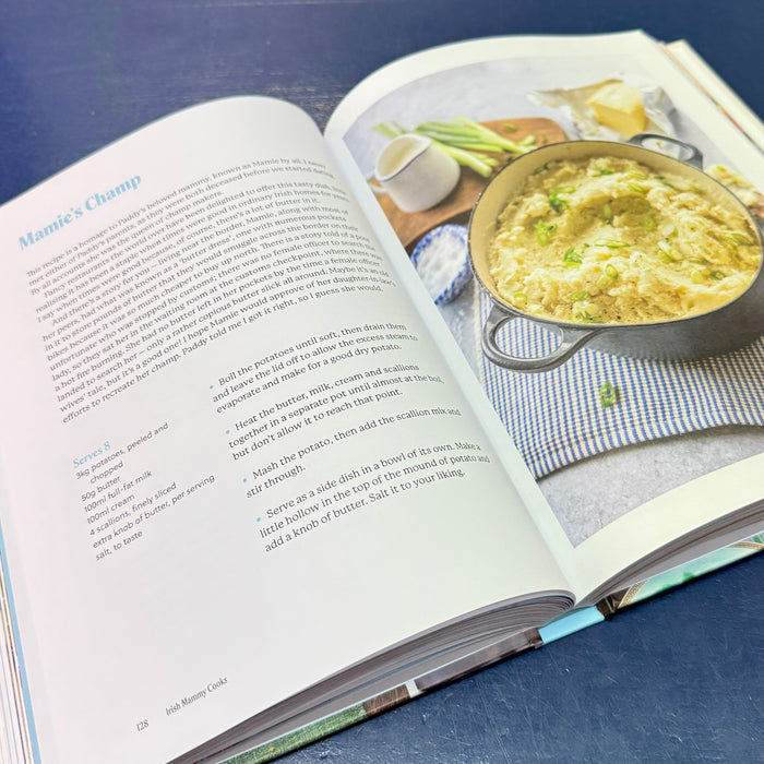 Open cookbook showing a recipe for Champ with a photo of a dish on a blue surface.