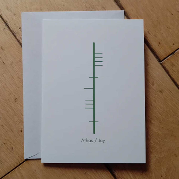 a white greeting card with green ogham writing on it
