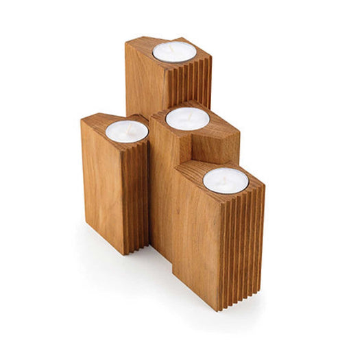 set of four wooden candle holders with a tealight in each on a white background