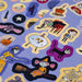 Halloween-themed stickers with various spooky illustrations on a purple background