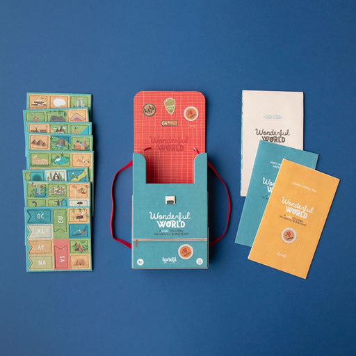 Collection of colorful tiles, an open backpack box, 3 booklets, with a blue background.