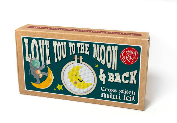 Cross stitch mini kit box with 'Love You to the Moon & Back' text and illustrations on a white background.