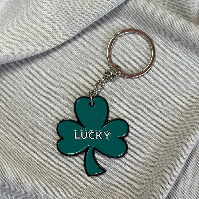 green shamrock keyring with  black outline and lucky in white text in centre