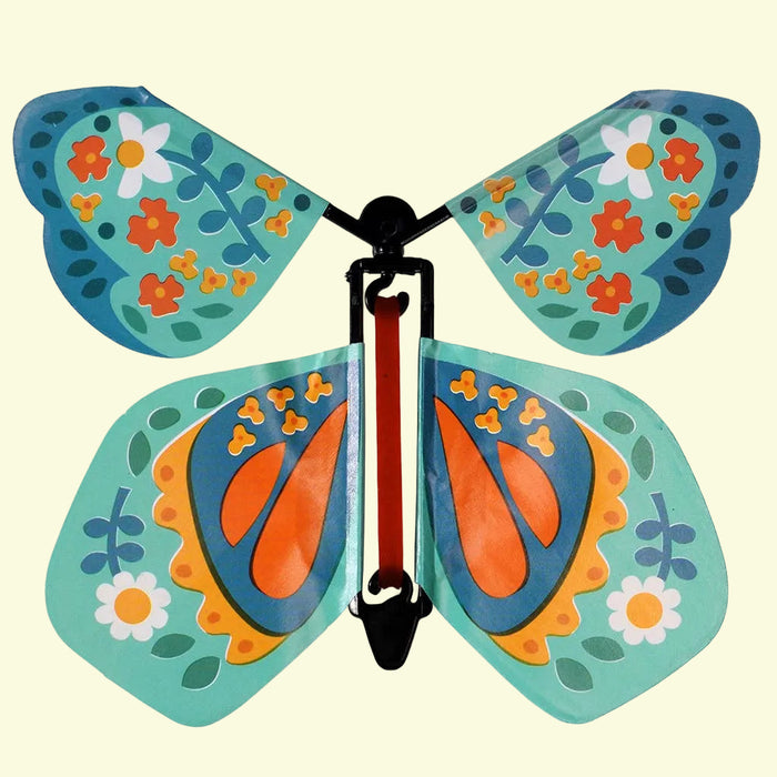 Colorful butterfly-shaped toy with floral patterns on a white background