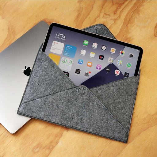 grey felt envelop with button open with electronic tablet sitting in it