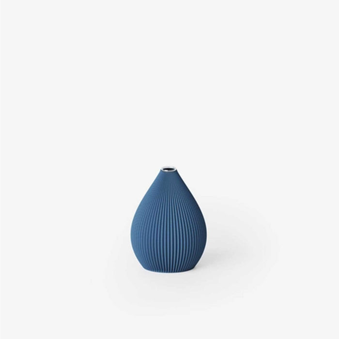 Blue textured vase on a white background