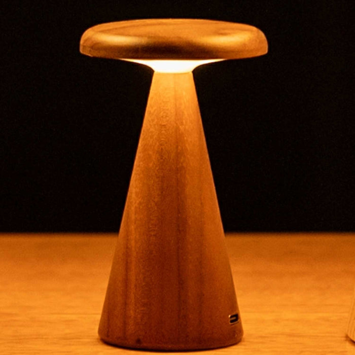 Mini Sylva table lamp. A conical dark walnut wood lamp, with flat wooden top  which is illuminated from below