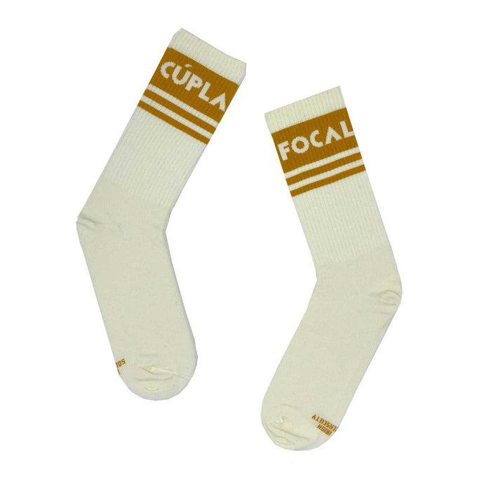 a pair of white socks with 3 light brown stripes on the ankle of each and irish text in the thickest stripe