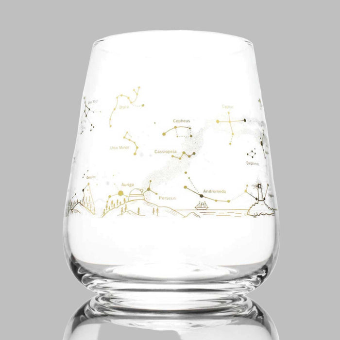 stemless wine glass with gold foil design of the night sky constellations on the outside