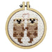 Cross-stitched design of two otters holding hands in a wooden hoop on a white background