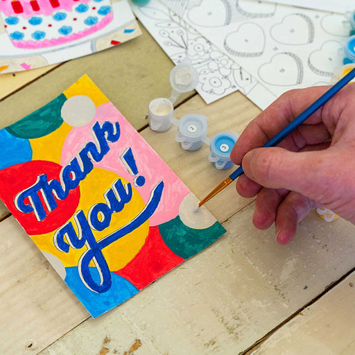 Hand painting a Thank You card wth a small paintbrush