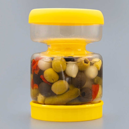 a yellow and glass jar with 2 sections. Olives, mini onions and pickles are in the bottom section