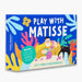 play with matisse activity craft kit box. Blue box with image of a man in glasses cutting shapes with a scissors while a black cat plays with cut out shapes on a table