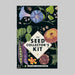 The Seed Collectors Kit card box. Dark green with colourful flowers, leaves and pea in the pod on the cover of the box