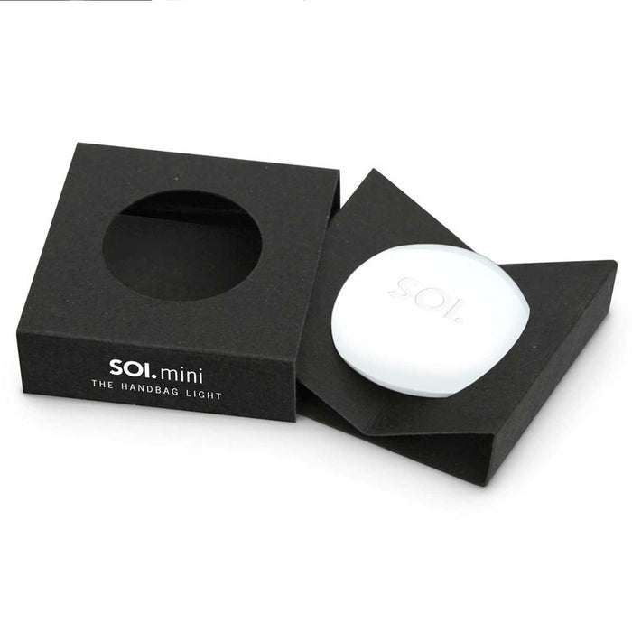 round, white soi mini handbag light in a black product box
