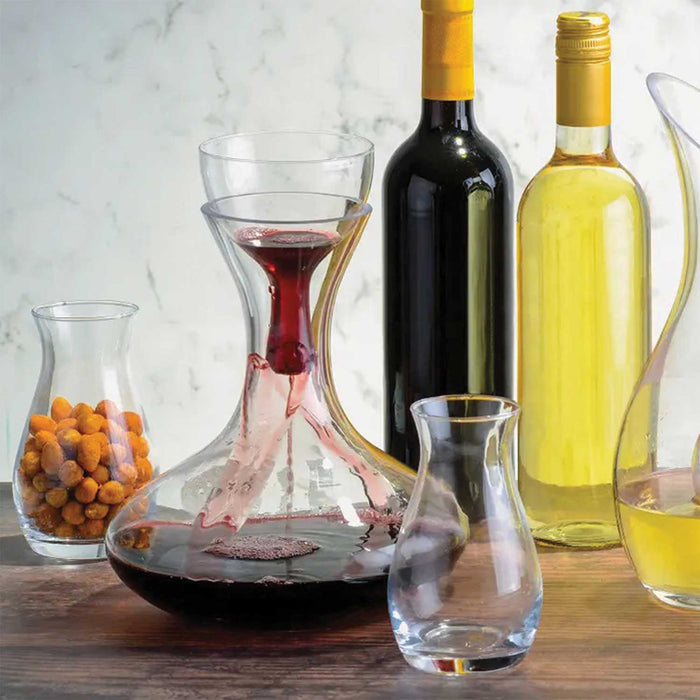 glass red wine carafe with aerator on a table with a bottle of red and a bottle of whtie wine and two galsses