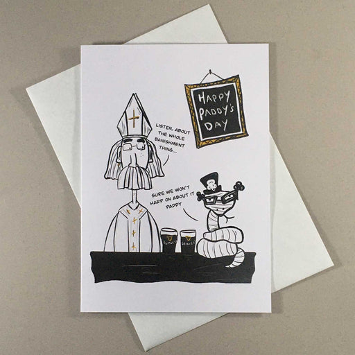 greeting card with drawing of a man in a bishops hat with a beard sitting beside  snake in a shamrock had and glasses with 2 pints of guiness between them