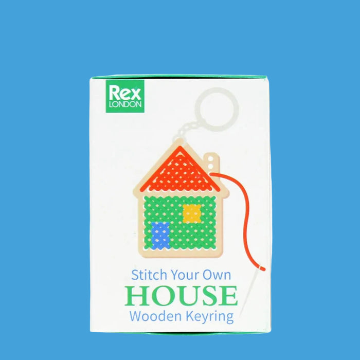 Packaging of a 'Stitch Your Own House' wooden keyring with Rex London branding.