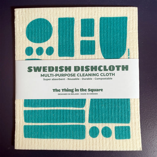 swedish dishcloth, with cloth with blue shaped and paper product wrap on a blue background