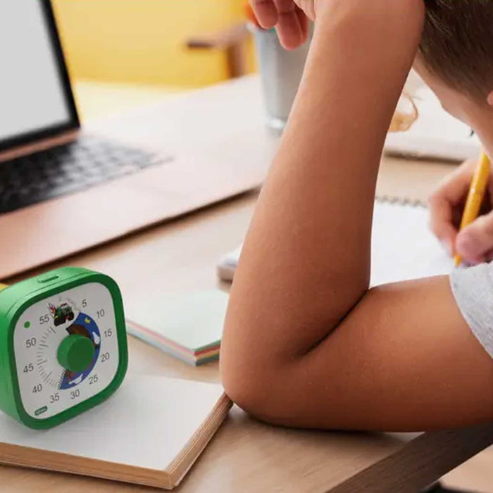 Child studying with a timer on a desk next to a laptop