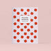 Plantable notebook with red and green tomato pattern on a pink backdrop